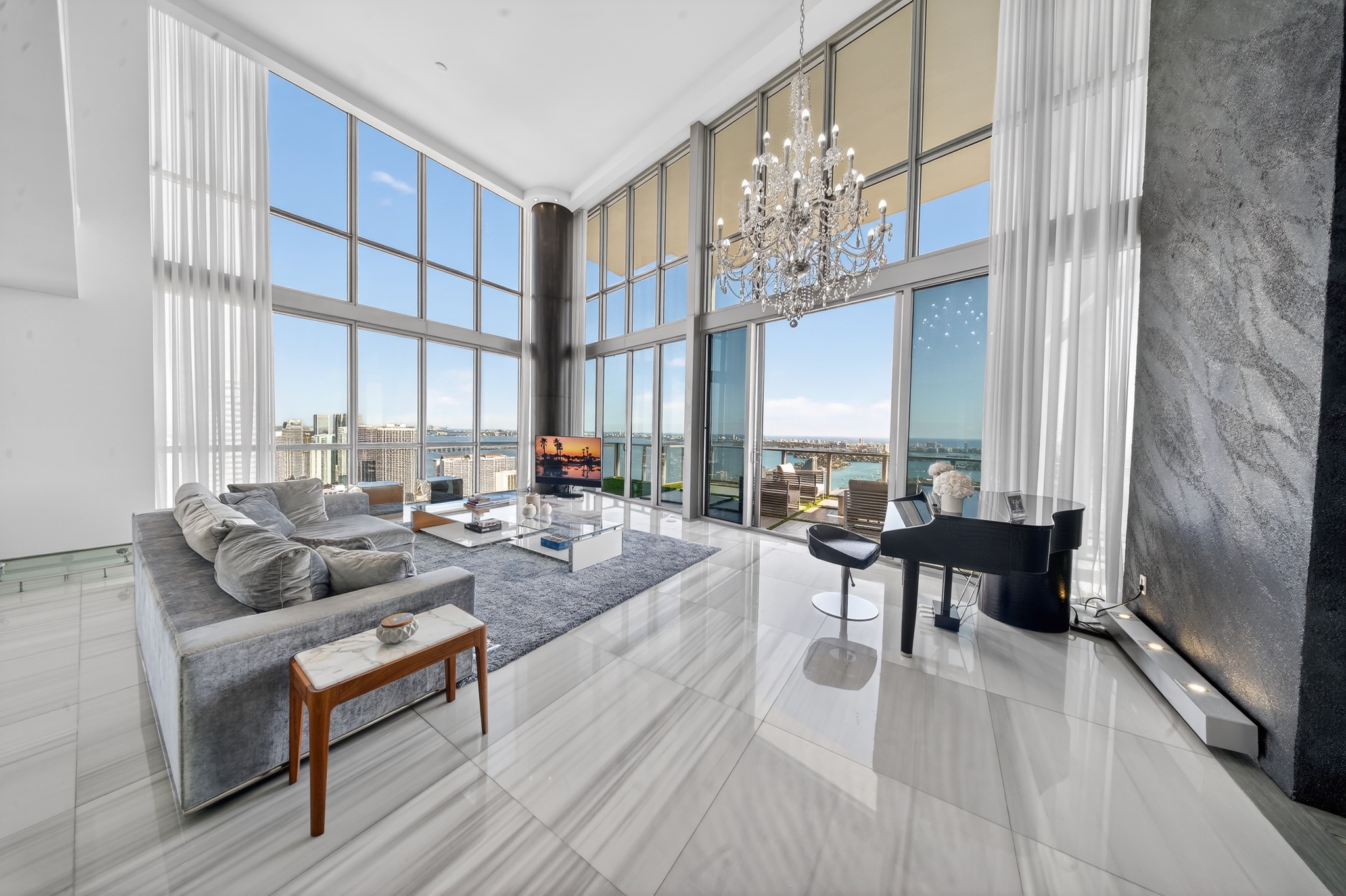 The double-height living room and waterfront terrace at Marquis Residence 5306
